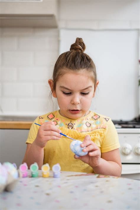 Child Girl Of Preschool Age Painting Easter Eggs At Home Kitchen