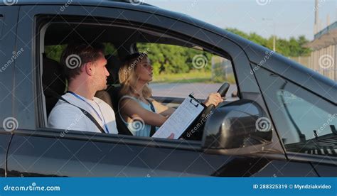 View Of Driving Instructor Holding Checklist While In Background Female
