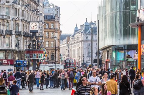 Lots Of People Tourists And Londoners Walking Via Leicester Square