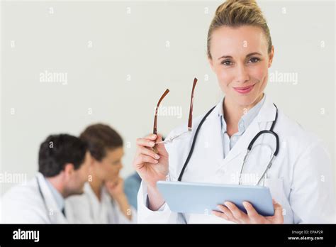 Doctor Holding Digital Tablet And Glasses Stock Photo Alamy