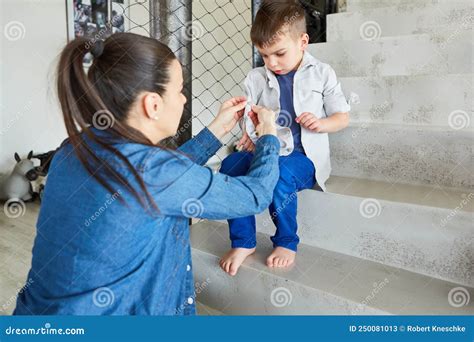 Mom Helps Her Son Put On Shirt Stock Image Image Of Care Lifestyle 250081013