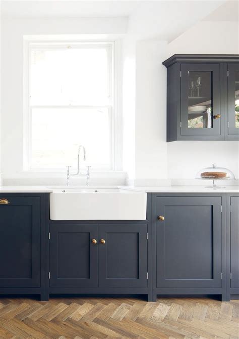 Shaker style kitchen cabinets are known for their versatility. navy & brass shaker style cabinets | Kitchen cabinet styles