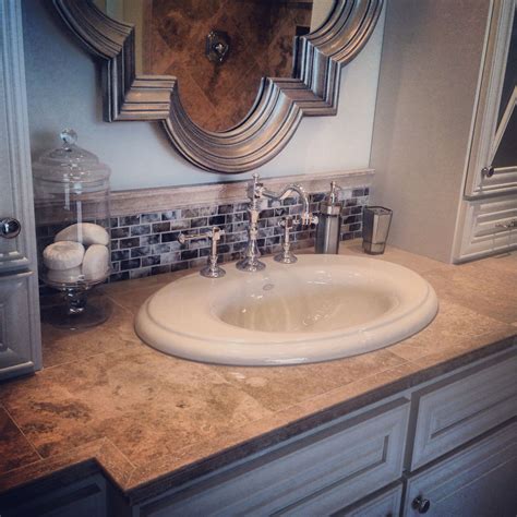 Bathroom trends to watch out for in 2021. Travertine tile countertop for the vanity. #thetileshop ...
