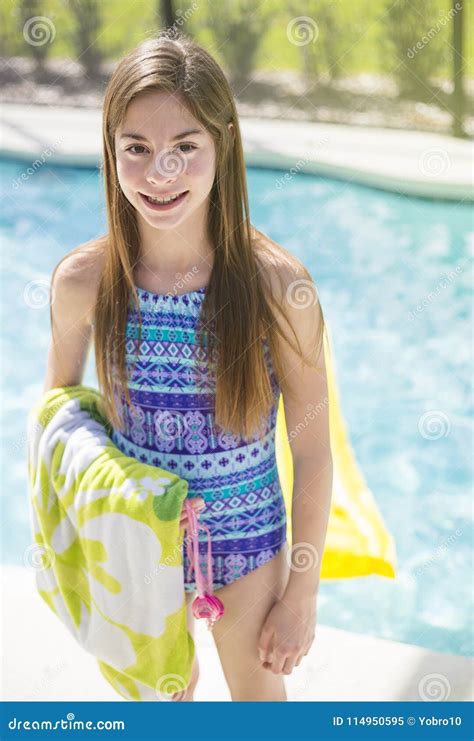 Teenage Girl Going Swimming In An Outdoor Pool During Summer Vaction