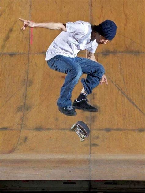 A Man Flying Through The Air While Riding A Skateboard On Top Of A