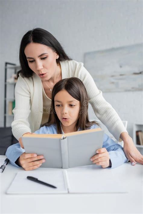 Brunette Nanny Helping Girl Reading Book Stock Image Image Of Cute