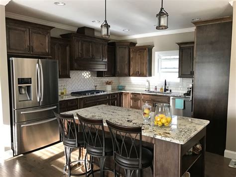 Complete the look with a cool grey backsplash and gorgeous waterproof plank. Dark Walnut stained cabinets, Alaska White Granite. White ...