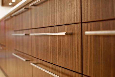 Warm finishes like brass and gold tend to elevate cabinetry with a more sophisticated vibe. Stainless Steel Post & Rail Bar Cabinet Handles | DCH Online