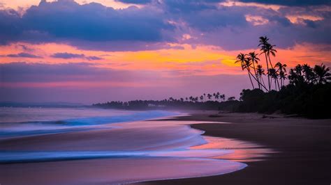 Download 1600x900 Beach Sunset Waves Clouds Sky Palms