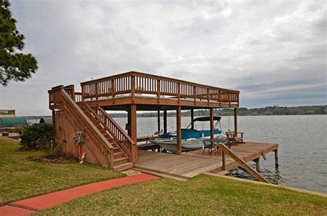 Double Slip Fishing Dock On Right Ground Level Open Top Lake House