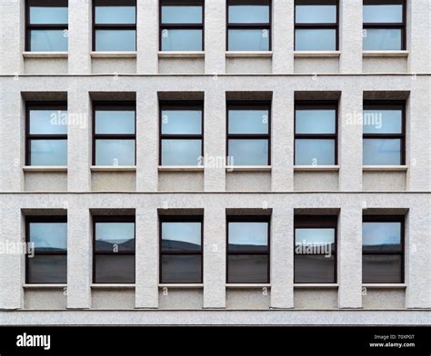 Close Up And Pattern Of Windows With Blue Glass On The Facade Of A