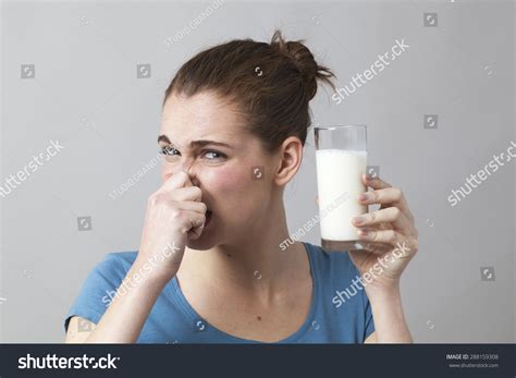 Young Woman Not Willing To Drink A Glass Of Smelly Milk Or Disgusting