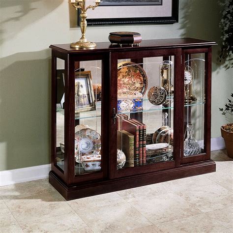 It is a cabinet made of glass based on a steel frame. Darby Home Co Purvoche Lighted Console Curio Cabinet ...