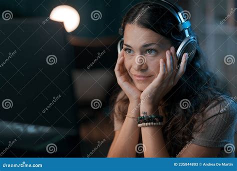 Young Woman Wearing Headphones And Watching A Video Stock Image Image