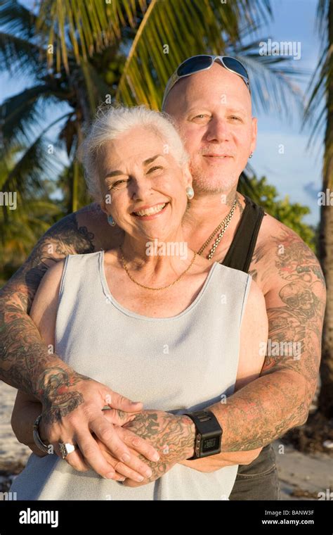 Mother And Tattooed Son Hugging At The Beach Stock Photo Alamy