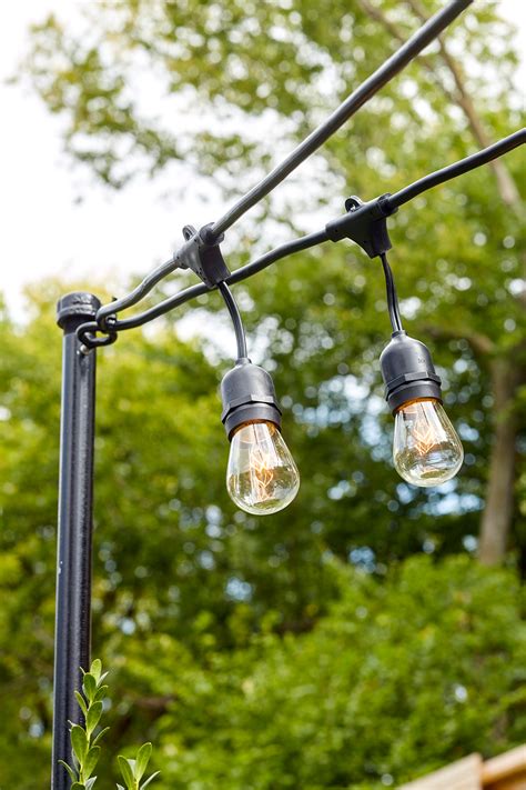 Hang the lights around the perimeter of the space, crisscrossing the area if desired. Light Pole For Backyard
