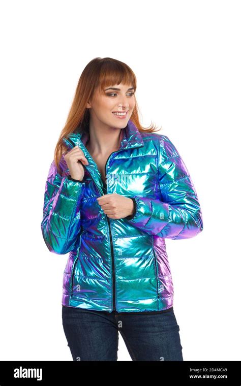 Young Woman Is Posing In Vibrant And Shiny Down Jacket And Holding