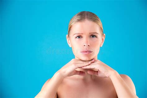 Close Up Beauty Portrait Of Young Woman Blonde Touching Her Face On