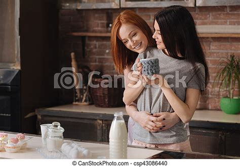 Positive Delighted Lesbians Hugging One Another Happy Together