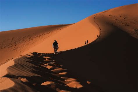 Person Walking On Sand Dunes During Daytime Photo Free Sossusvlei