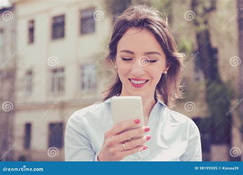 Beautiful Woman Using Her Mobile Phone In The Street Stock Image