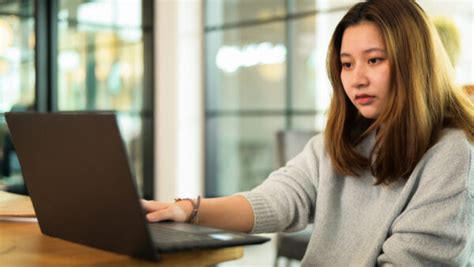 Asian Teenage Girl Using Laptop On The Desk Online Learning Vi