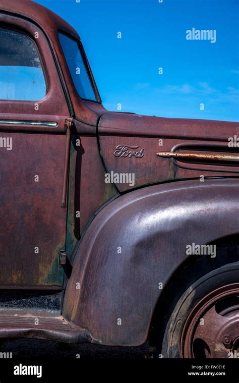 Abandoned Ford Pickup Truck Rusting In A Field In Wyoming Stock Photo