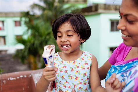 Mother And Daughter Enjoying An Ice Cream On A Hot Day By Saptak Ganguly