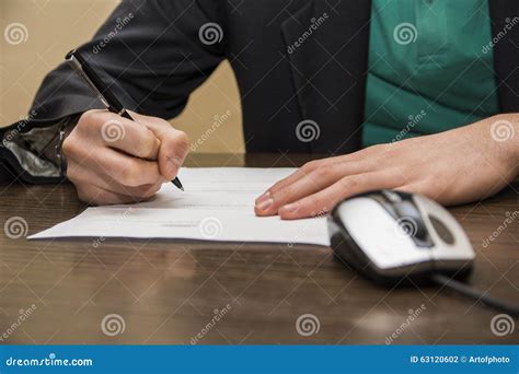 Hands Of Man Signing A Sheet Of Paper Or Document Stock Photo Image