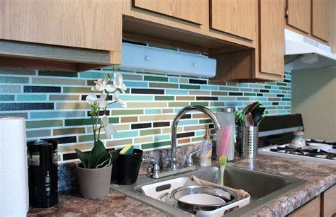 A glass backsplash is easy to clean, so you don't have to worry about food spatters getting on walls. Affordable DIY Backsplash - Mosaic Tile Paint Project