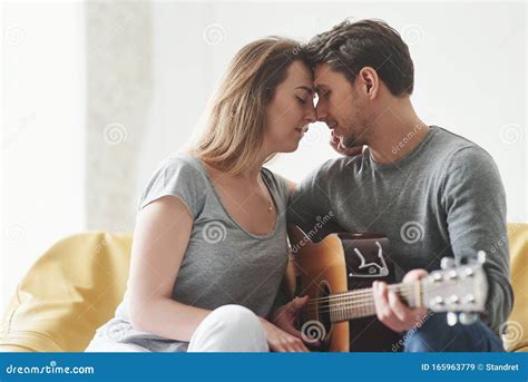 Touching And Kissing Playing On Acoustic Guitar For The Girlfriend In