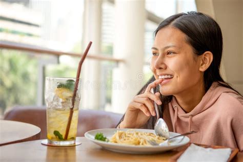 Happy Smiling Asian Woman Eating Italian Pasta With Lemonade In