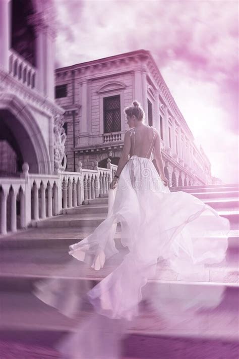 Woman Wearing Beautiful White Dress Walking On A Street Of The Venice