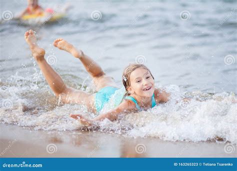 Girl In A Turquoise Bathing Suit In The Sea Happy Children Swimming In