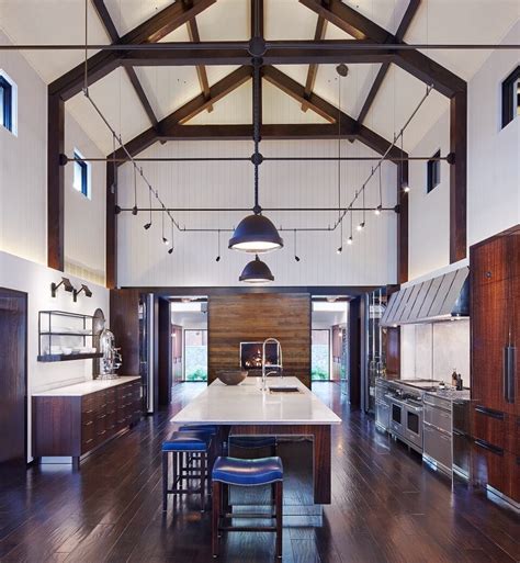 Exposed beams are often a darker color than the rest of the room, creating stark contrasts that catch the eye. This kitchen's vaulted ceiling and exposed beams give it a ...