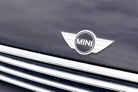 Retail Of Austin Mini Cooper Logo On Blue Car Parked In The Street