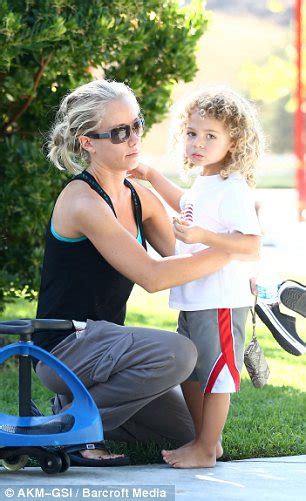 kendra wilkinson shares a kiss and a cuddle with her son hank jr as pair enjoy a play date in