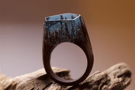 Make a secret wood ring, casting epoxy resin. Snowy Mountains and Undersea Worlds Encapsulated Within Wood and Resin Rings | Colossal