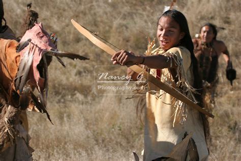 Three Native American Indian Men Hunting With A Bow And Arrow In