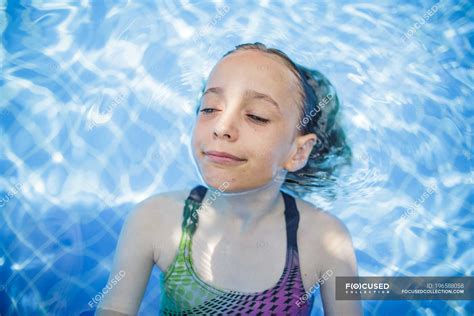 A Girl Is Having Fun In A Swimming Pool During Vacation — Adventure