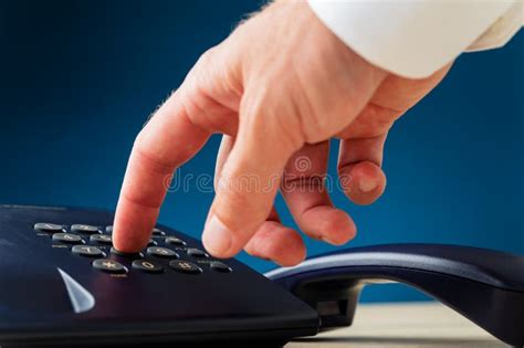 Closeup View Of Male Hand Dialing A Telephone Number Stock Image