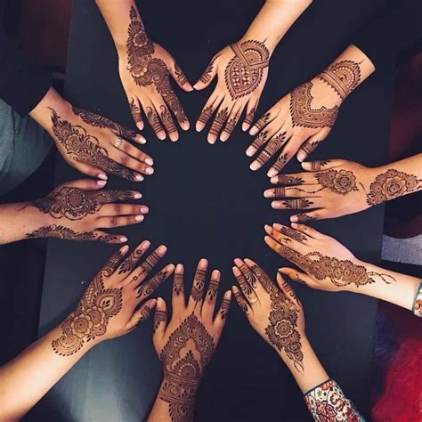 Many Hands Are Arranged In The Shape Of A Circle With Henna Tattoos On Them