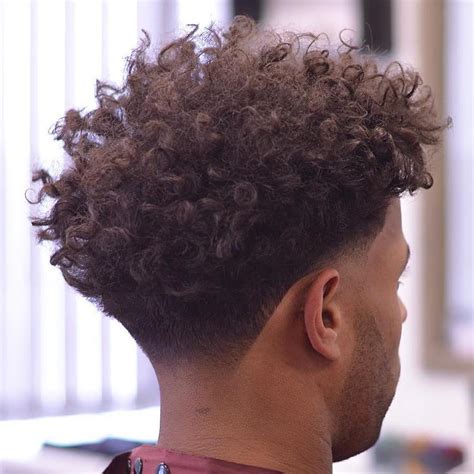 This modern style has a very short top with a seamless transition to a skin fade on the for longer curls on top and for black hair, this is an expert cut that requires a drop fade that follows the flow of your hairline and gradually blends into your curls. 40 Devilishly Handsome Haircuts for Black Men