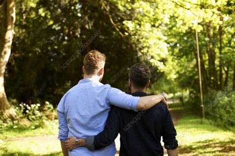 affectionate male gay couple hugging walking stock image f022 3252 science photo library