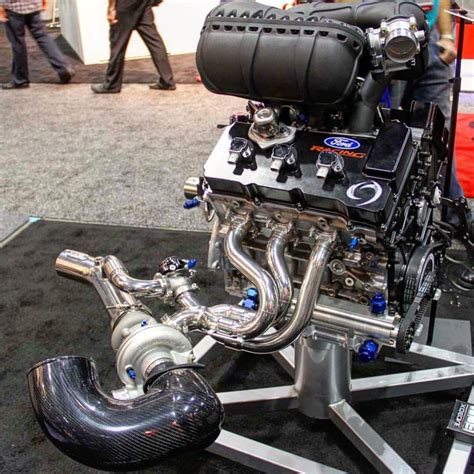 An Engine On Display In A Showroom With People Walking Around And