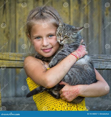 Funny Little Girl Holding A Cat In Her Arms Love Stock Image Image
