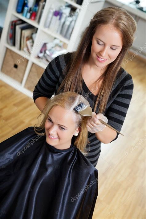 Beautician Applying Hair Colour To Woman Stock Photo By ©simplefoto
