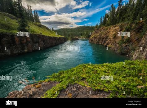 Water Flows Through Miles Canyon Whitehorse Yukon Canada Stock Photo