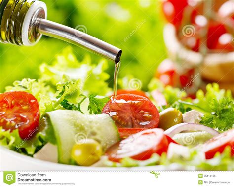 Each salad was served with 3 grams, 8 grams or 20 grams of fat from dressing. Olive Oil Pouring Over Salad Stock Photo - Image: 35118166
