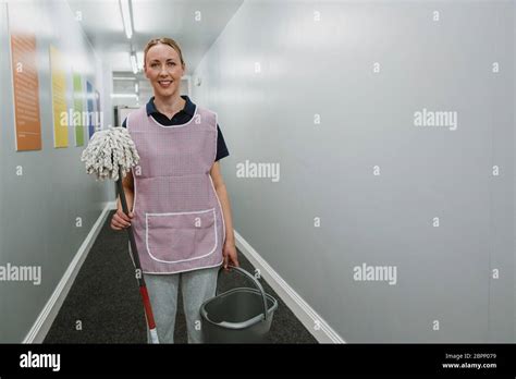 Portrait Of A Mature Female Cleaner With A Mop And Bucket In The